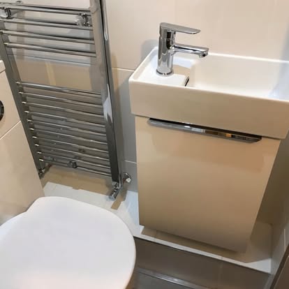 Compact cloakroom sink and heated towel rail installation